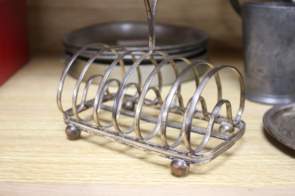 A Victorian silver plated chamberstick, pewter tankards, plates and a toast rack